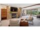 Inviting living room features a stone fireplace, recessed lighting, and floor-to-ceiling doors that let in natural light at 33448 Alta Vista Dr, Evergreen, CO 80439