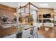 Open floor plan showcases spacious dining and living areas with wood accents, a modern fireplace and ample natural light at 33448 Alta Vista Dr, Evergreen, CO 80439
