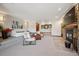 Living room with stone fireplace, neutral decor, and large doorways that create an open and inviting living space at 33448 Alta Vista Dr, Evergreen, CO 80439