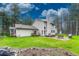Spacious backyard with outdoor seating, patio, lush lawn, and mature landscaping at 18470 Canterbury Dr, Monument, CO 80132