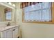 Charming bathroom with a granite vanity and a window that brings in natural light at 18470 Canterbury Dr, Monument, CO 80132