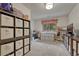 Large carpeted room with organized shelving units, a sewing station, and a window with a view of the trees at 18470 Canterbury Dr, Monument, CO 80132