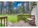 Inviting wooden deck with table and chair overlooking a serene, wooded backyard at 18470 Canterbury Dr, Monument, CO 80132