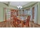 Inviting dining room featuring wood floors, natural light, and a classic chandelier at 18470 Canterbury Dr, Monument, CO 80132