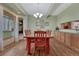 Dining area with wood floors, chandelier, and wooden cabinets with granite countertops at 18470 Canterbury Dr, Monument, CO 80132