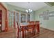 Charming dining area with wood table, chandelier, and scenic outdoor views at 18470 Canterbury Dr, Monument, CO 80132