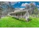Well manicured lawn surrounds the home, enhanced by mature trees and a cozy porch at 18470 Canterbury Dr, Monument, CO 80132
