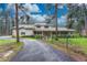 Charming two-story home with a covered porch, mature trees, and a long driveway at 18470 Canterbury Dr, Monument, CO 80132