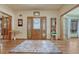 Inviting foyer with hardwood floors, decorative rug, and charming decor at 18470 Canterbury Dr, Monument, CO 80132