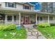 Inviting front porch with stone pathway, decorative planters, and well maintained greenery at 18470 Canterbury Dr, Monument, CO 80132