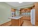 Kitchen with island cooktop, light wood cabinets, and stainless steel appliances at 18470 Canterbury Dr, Monument, CO 80132