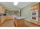 Bright kitchen with island cooktop, stainless steel oven, and light wood cabinets at 18470 Canterbury Dr, Monument, CO 80132