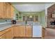Kitchen sink and dishwasher with a bar into the dining room, next to a stone fireplace at 18470 Canterbury Dr, Monument, CO 80132