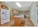 Open kitchen layout with island cooktop and view to the dining area at 18470 Canterbury Dr, Monument, CO 80132
