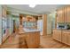Spacious kitchen with island cooktop, light wood cabinets, and granite countertops at 18470 Canterbury Dr, Monument, CO 80132
