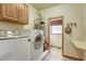 Functional laundry room equipped with washer, dryer, and storage, offering convenience and efficiency at 18470 Canterbury Dr, Monument, CO 80132
