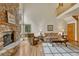 Living room view shows fireplace, wood floors, and a second story balcony at 18470 Canterbury Dr, Monument, CO 80132