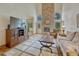 Spacious living room with a stone fireplace, wood floors, and comfortable seating at 18470 Canterbury Dr, Monument, CO 80132