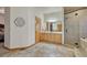 Well-lit main bathroom featuring a glass shower, tile floor, and wooden vanity at 18470 Canterbury Dr, Monument, CO 80132