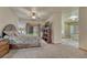 Serene main bedroom featuring a king bed, ceiling fan, and access to a spa-like ensuite bathroom at 18470 Canterbury Dr, Monument, CO 80132