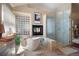 Bathroom features a soaking tub, glass shower, modern tile, and a cozy fireplace at 23 Hess Ave, Golden, CO 80401