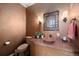 Stylish half-bathroom with unique sink, decorative mirror, and warm lighting at 23 Hess Ave, Golden, CO 80401