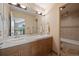Bathroom with double vanity, wood cabinets, large mirror, and a separate shower and toilet room at 23 Hess Ave, Golden, CO 80401