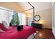Bedroom featuring wood floors and a red-covered four poster bed with light neutral walls at 23 Hess Ave, Golden, CO 80401