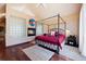 Bedroom boasts a fireplace, glass block windows, and a four-poster canopy bed with red bedding at 23 Hess Ave, Golden, CO 80401