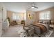 Staged bedroom with modern decor, neutral colors, a ceiling fan, and plenty of natural light at 23 Hess Ave, Golden, CO 80401