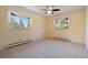 Bedroom featuring yellow walls, a ceiling fan, carpet flooring, and views of the trees at 23 Hess Ave, Golden, CO 80401