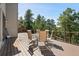 Outdoor dining area on a wooden deck with forest views at 23 Hess Ave, Golden, CO 80401
