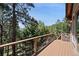 This wooden deck features forest views with black metal railings for a safe, relaxing outdoor experience at 23 Hess Ave, Golden, CO 80401
