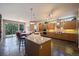 Spacious kitchen features a granite island with bar seating, modern appliances, and an adjacent dining area with stunning views at 23 Hess Ave, Golden, CO 80401