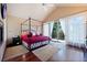 Serene main bedroom with a four-poster bed, balcony access, and hardwood floors at 23 Hess Ave, Golden, CO 80401