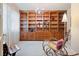 Well-lit office with custom wood built-in shelves, cabinets, and drawers, and a comfortable rocking chair at 23 Hess Ave, Golden, CO 80401