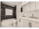 Bathroom offers a modern dual sink vanity and tiled shower/tub at 3200 S Federal Blvd # 5, Denver, CO 80236