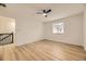 Light-filled bedroom with ceiling fan and wood-look floors near landing at 3200 S Federal Blvd # 5, Denver, CO 80236