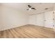 This bedroom features a ceiling fan, wood-look floors, and closet doors at 3200 S Federal Blvd # 5, Denver, CO 80236