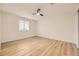 Bright bedroom boasts sleek ceiling fan, window, and wood-look floors at 3200 S Federal Blvd # 5, Denver, CO 80236
