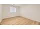 Bedroom featuring wood-look floors and a window with blinds at 3200 S Federal Blvd # 5, Denver, CO 80236