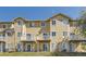 Back exterior view of tan home with balconies and windows at 3200 S Federal Blvd # 5, Denver, CO 80236