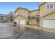 Inviting townhome showcasing an attached garage and covered front entrance at 3200 S Federal Blvd # 5, Denver, CO 80236