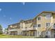 Exterior back view of multiple homes with balconies and yard at 3200 S Federal Blvd # 5, Denver, CO 80236