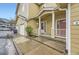 Close-up of a townhome's entrance featuring an open porch with supporting columns at 3200 S Federal Blvd # 5, Denver, CO 80236
