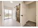 Hallway with rustic wood sliding door, closet, and sliding glass doors at 3200 S Federal Blvd # 5, Denver, CO 80236