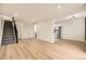 Spacious living room with a stairway adjacent to the kitchen area at 3200 S Federal Blvd # 5, Denver, CO 80236