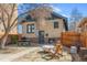 Backyard with patio, seating, mature trees, wooden fence, and house view at 525 N Pearl St, Denver, CO 80203