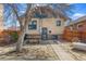 Backyard with brick veneer, stone pathway, wooden fence, picnic table, and mature tree at 525 N Pearl St, Denver, CO 80203