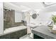 Bathroom featuring a shower over the bathtub, pedestal sink, and tile accent wall at 525 N Pearl St, Denver, CO 80203